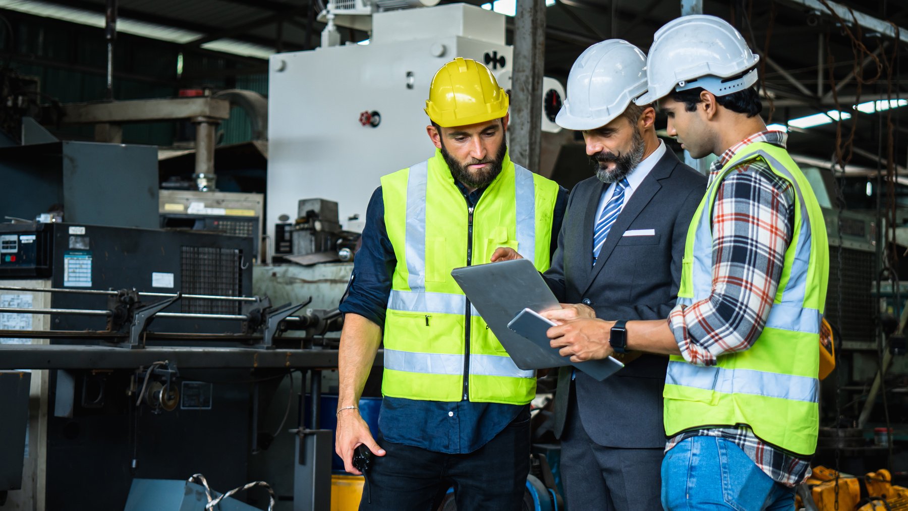 Industrial Engineer in Suite and Safety Helmet Working in Factor