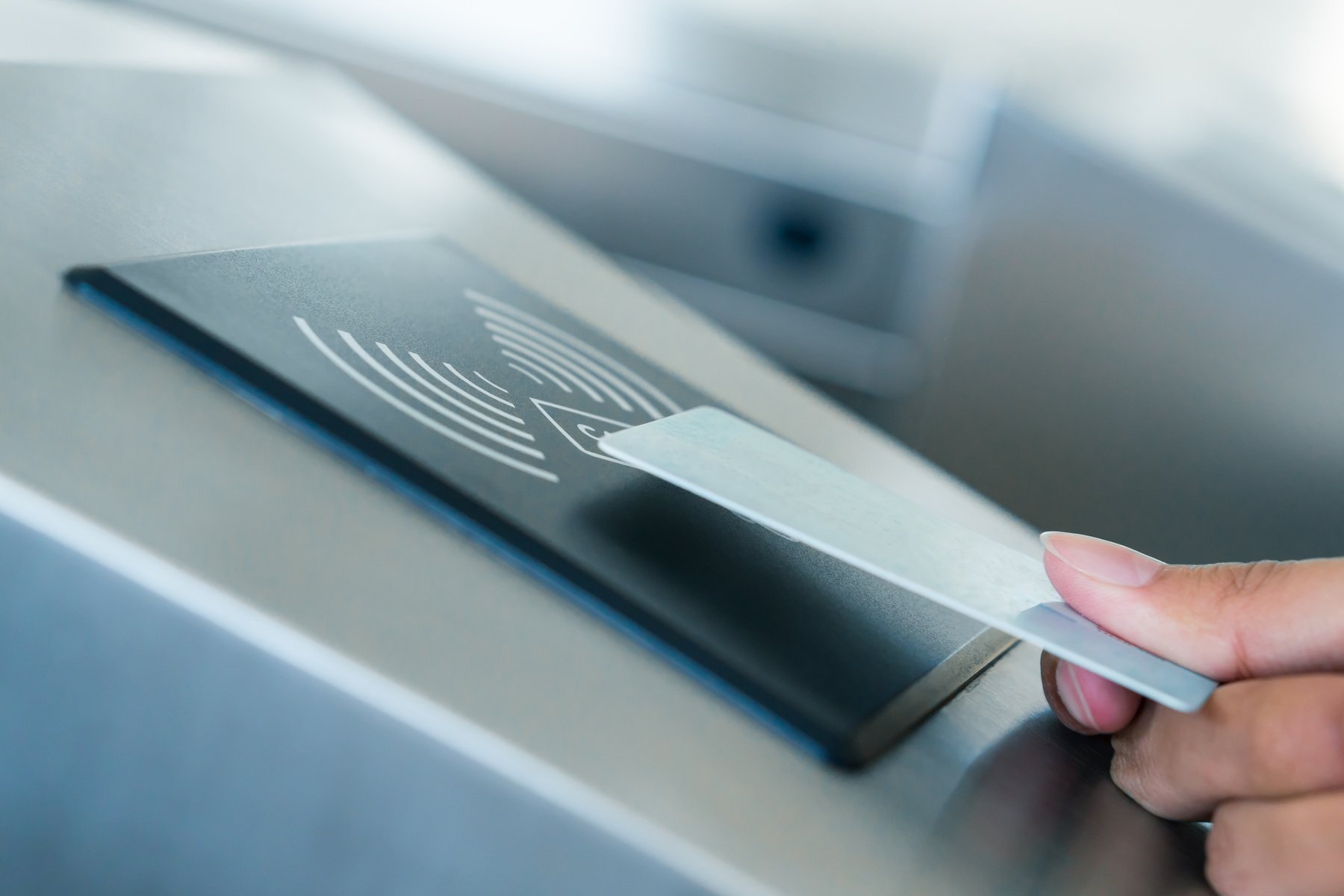 Hand holding Blue Card to access Electronic Entrance